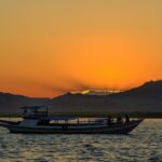 Overnight dhow cruise in Musandam fjords with scenic mountains and calm sea