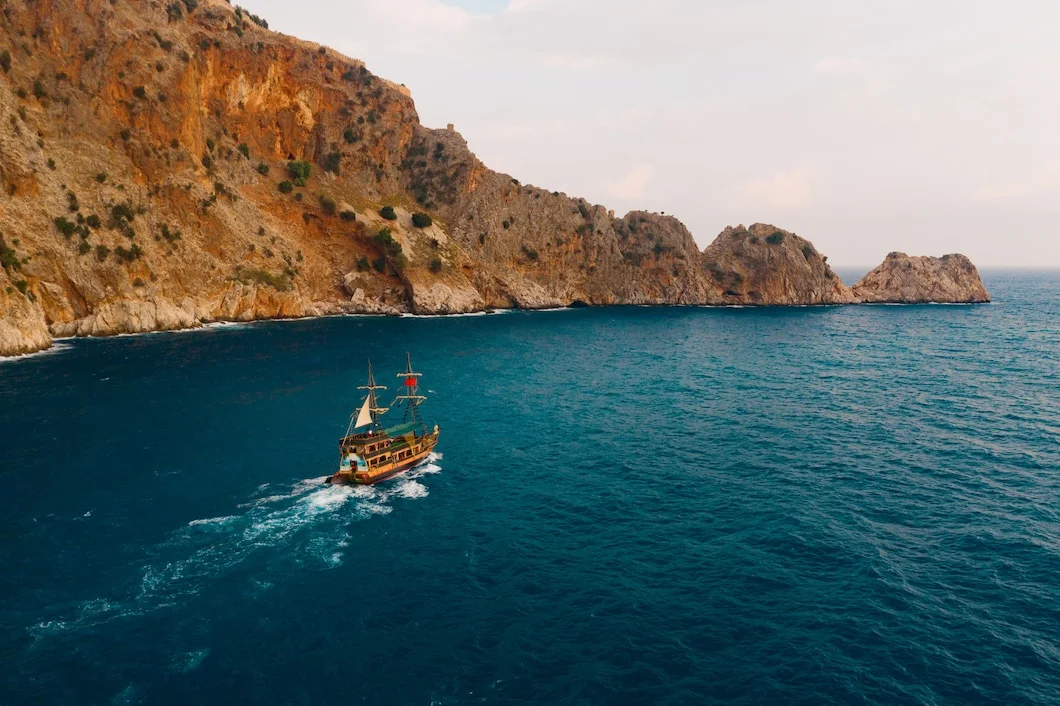 Traditional dhow cruise during a Musandam overnight tour from Dubai surrounded by mountains and calm sea