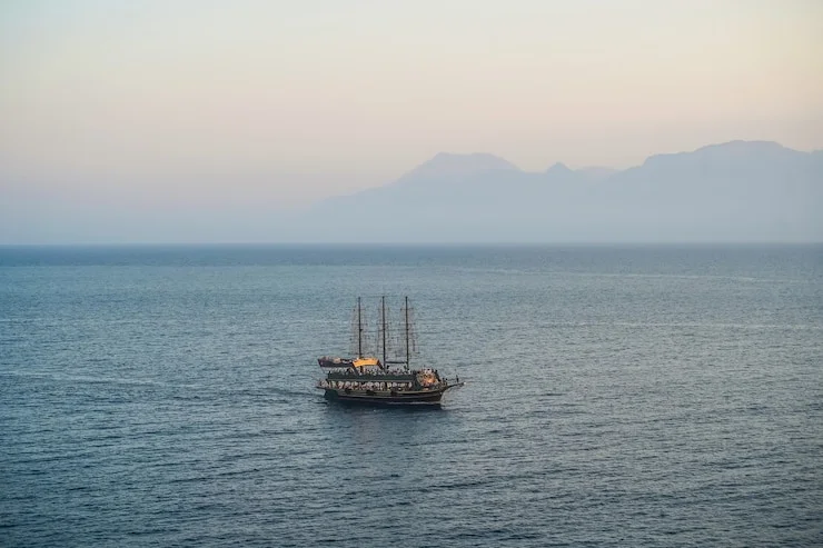 Musandam dhow cruise overnight during sunset through scenic fjords